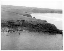 Rockfalls along the Bering Sea coastline caused by the Cannikin detonation. Photo taken on D + 1 day.